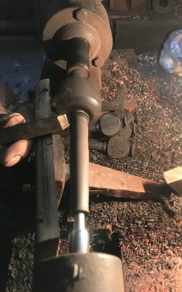 Pentacle India craftsmen hand-shaping violin pegs at workshop workstation