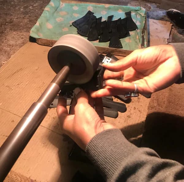 Hand finishing and polishing of cello tailpieces and endpins